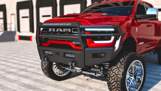 Red 2025 Ram 2500 with a heavy-duty ranch bumper on a concrete surface.